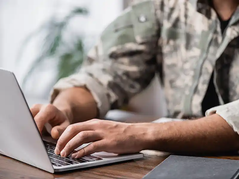 Military personnel using laptop