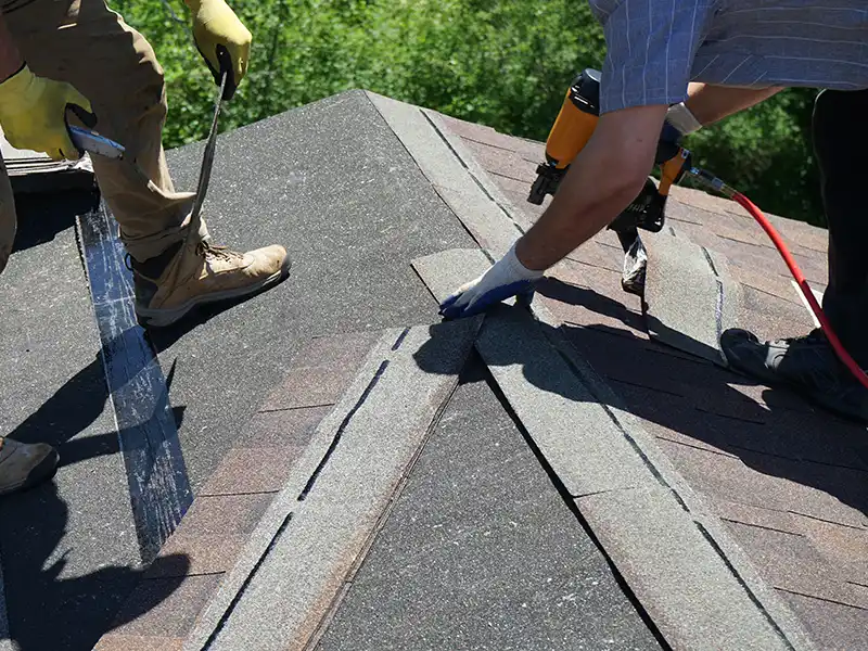 Roofers installing new shingles
